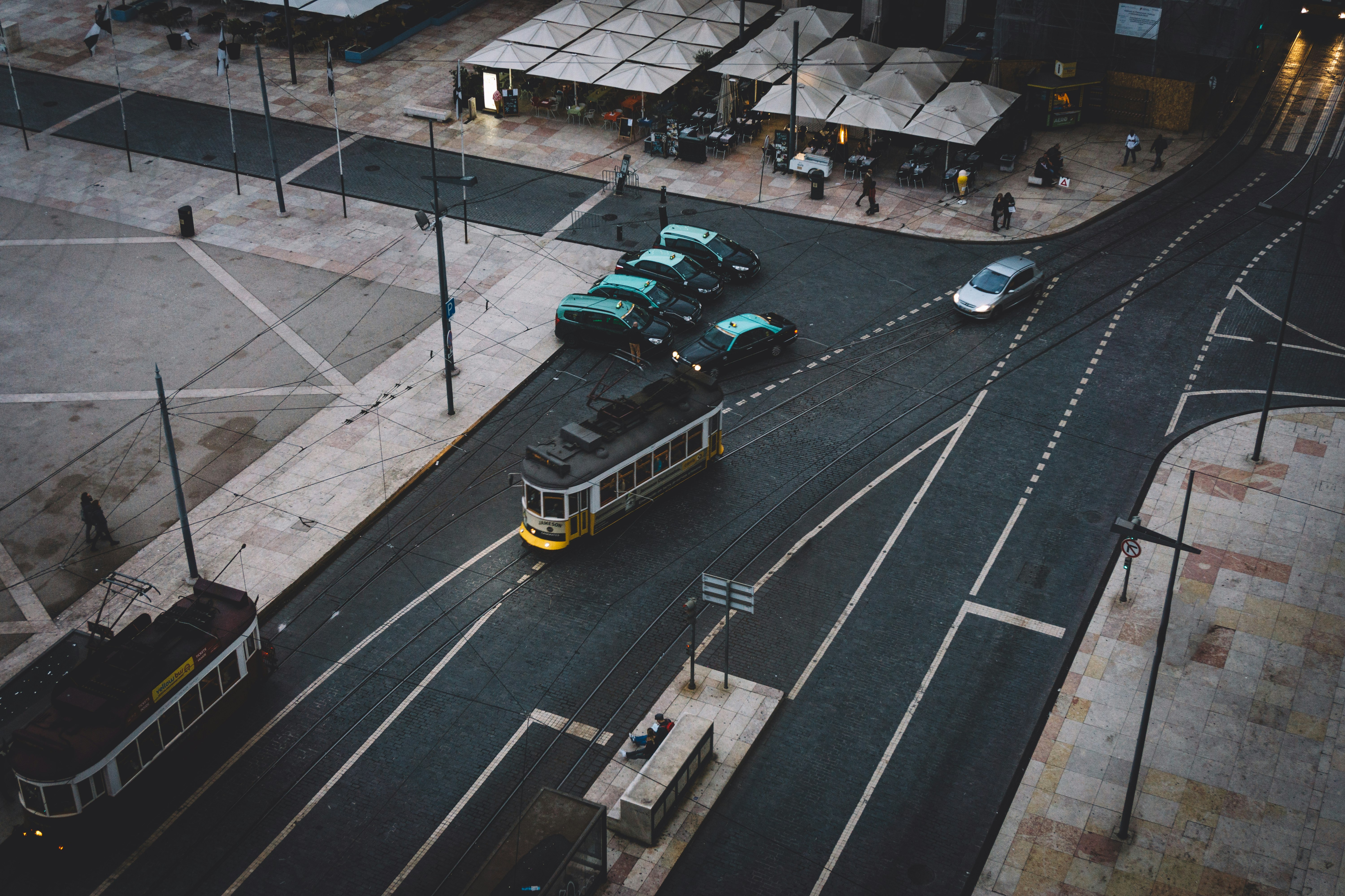 assorted-color vehicles parked beside high rise building